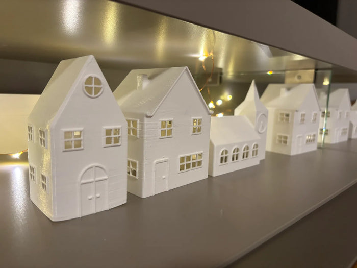 Matte white 3D printed winter village house luminaries lit with fairy lights