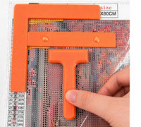 Orange three-piece diamond painting tool set: right-angle ruler, straight ruler and T drill straightener on a canvas – image 10