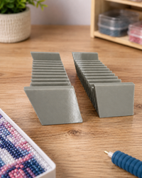 Pair of grey 3D printed 12-slot tilted drill packet trays on a craft table – image 2