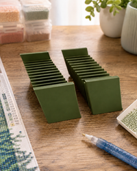 Pair of olive green 3D printed 12-slot tilted drill packet trays on a craft table – image 8