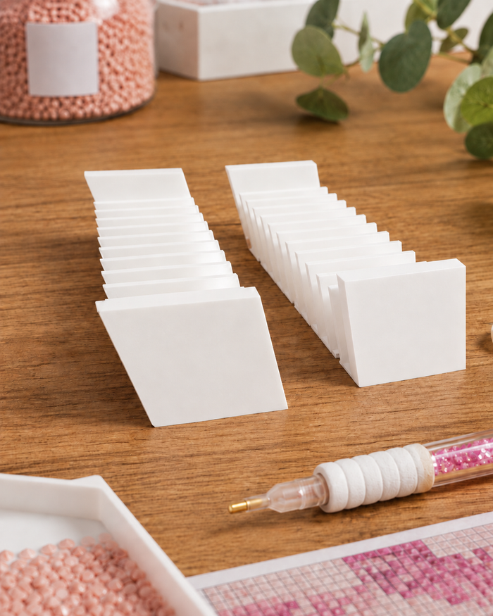 Pair of white 3D printed 12-slot tilted drill packet trays on a craft table