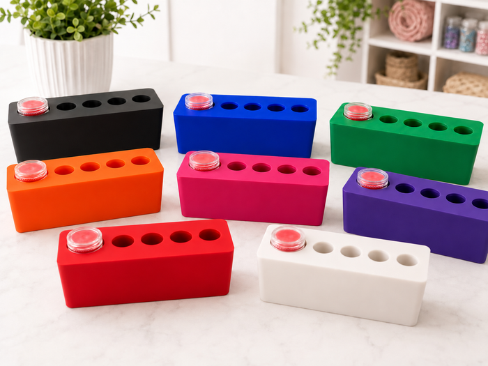 Drill Pen Station in all eight colors: black, blue, green, orange, pink, purple, red and white, each with a wax refill