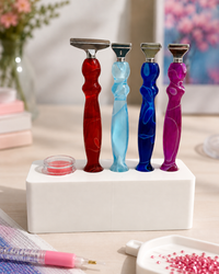 White Drill Pen Station holding four resin drill pens, with wax in the wax well, on a craft table – image 7