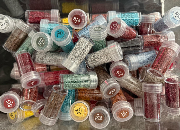 Round diamond painting replacement drills in labelled DMC screw-top jars, 20 colours